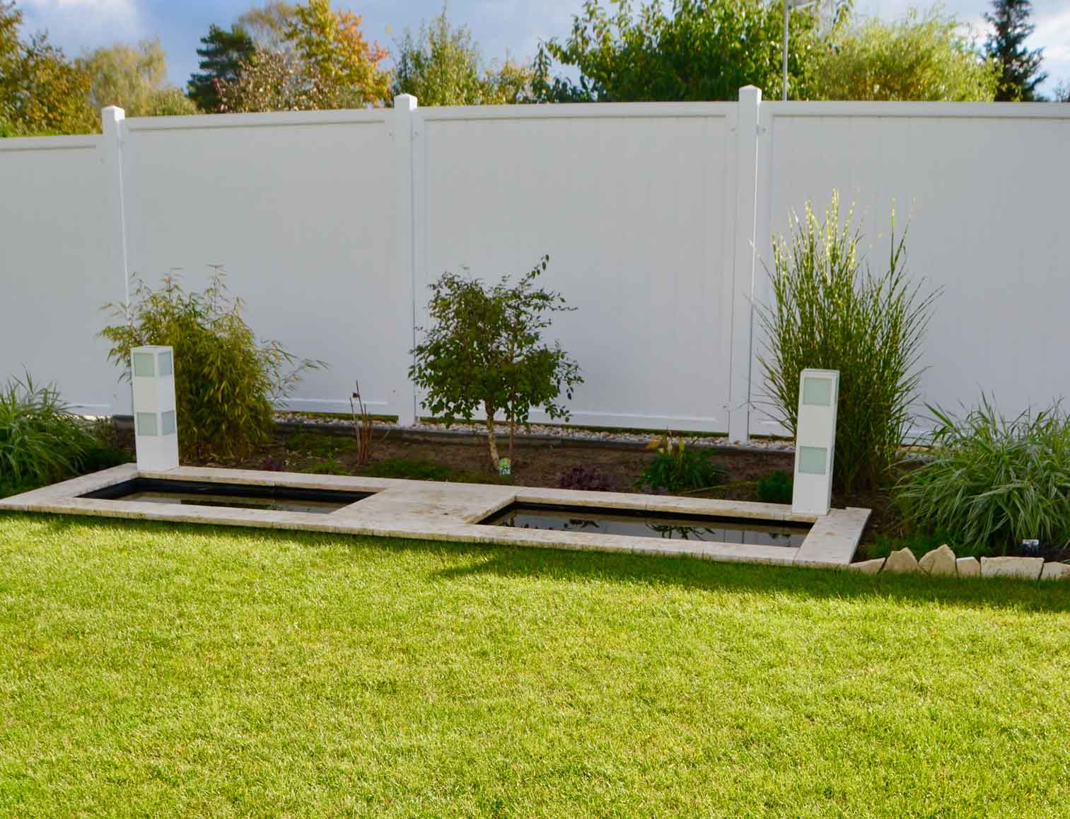 Sichtschutzzaun aus Kunststoff PVC in Weiß mit Massivrahmen im Garten